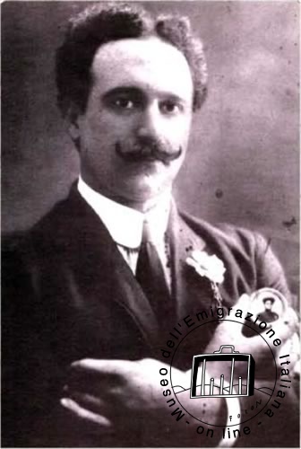 Giuseppe Piagentini pictured holding a photograph of his far-away fiancée