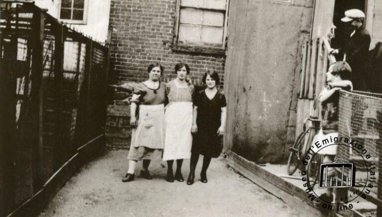 U.S.A., New York. Paola Franchi, in the centre of the picture, with two friends in her courtyard